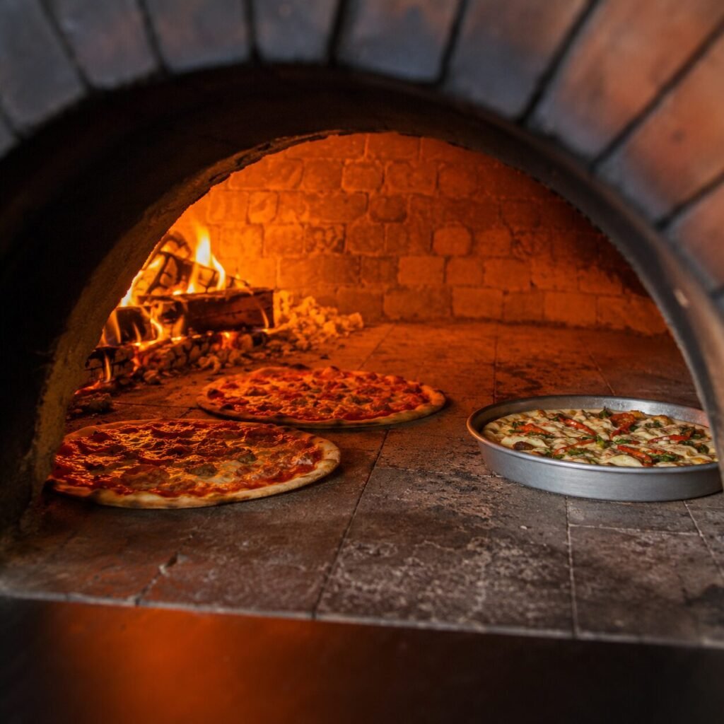 Pizza baking in a restaurant oven on a separate protective tray